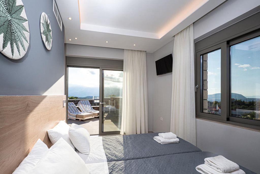 Upstairs twin bedroom with roof-terrace access