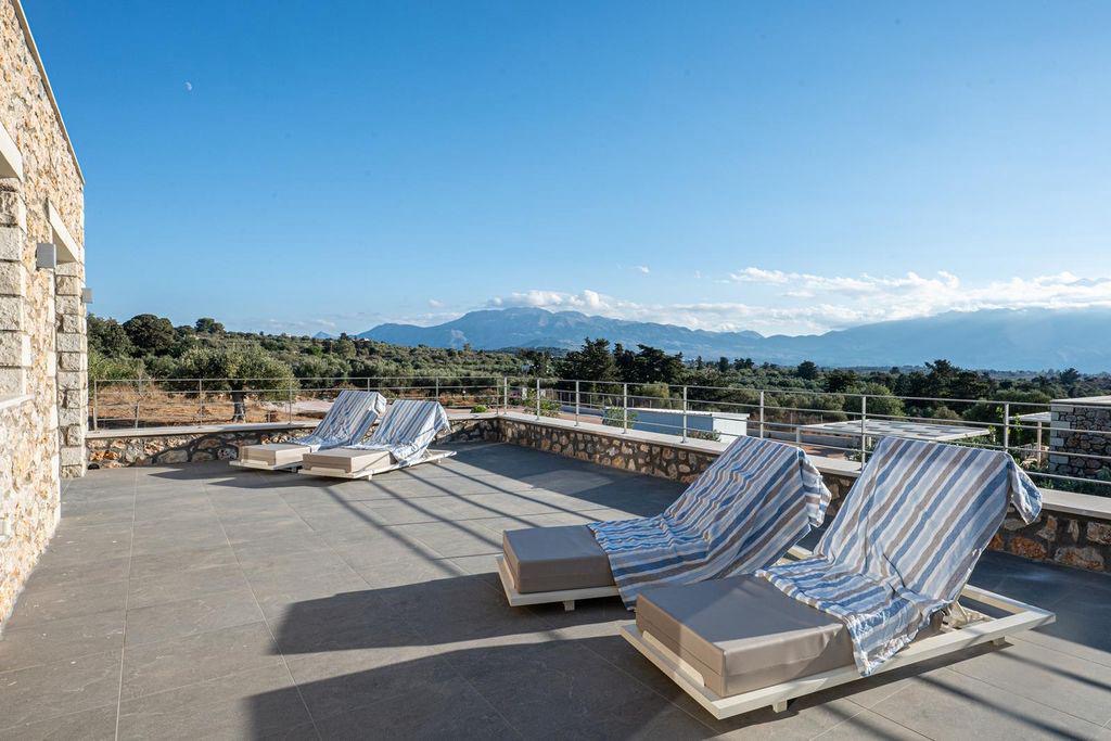 Roof terrace with sun loungers and mountain views